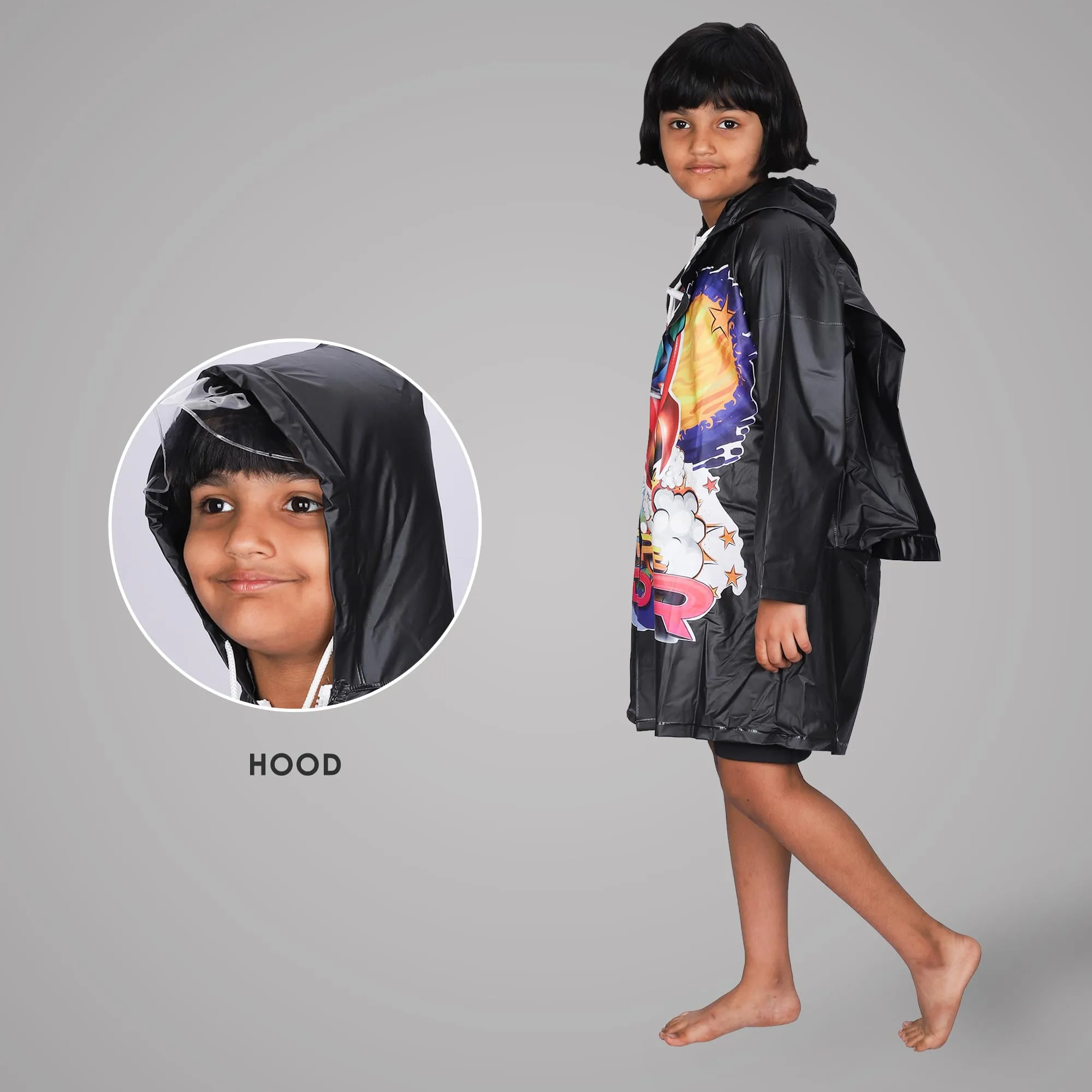 THE CLOWNFISH Toon Caper Series Kids Waterproof PVC Longcoat with Adjustable Hood & Extra Space for Backpack/Schoolbag Holding. Printed Plastic Pouch. Kid Age-6-7 years (Black)